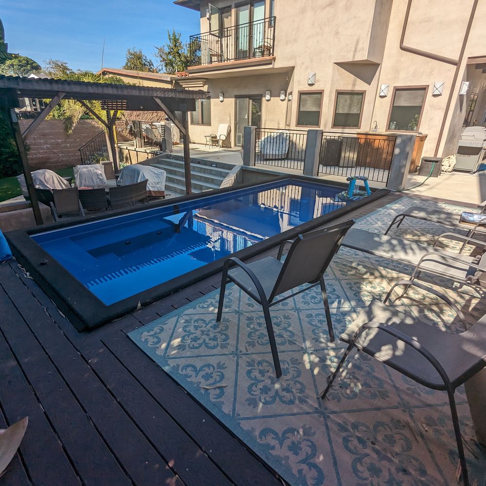 Pool deck and patio seating at dusk