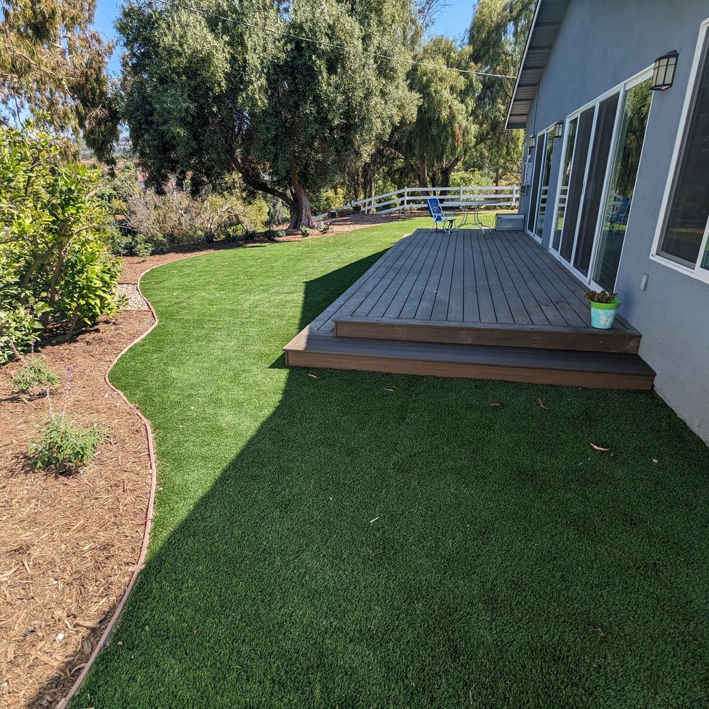 Wood deck beside a new lawn and planting bed