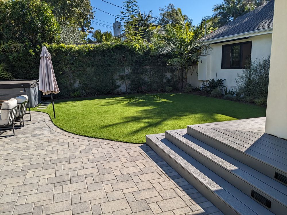 Curved paver path and steps beside a lawn